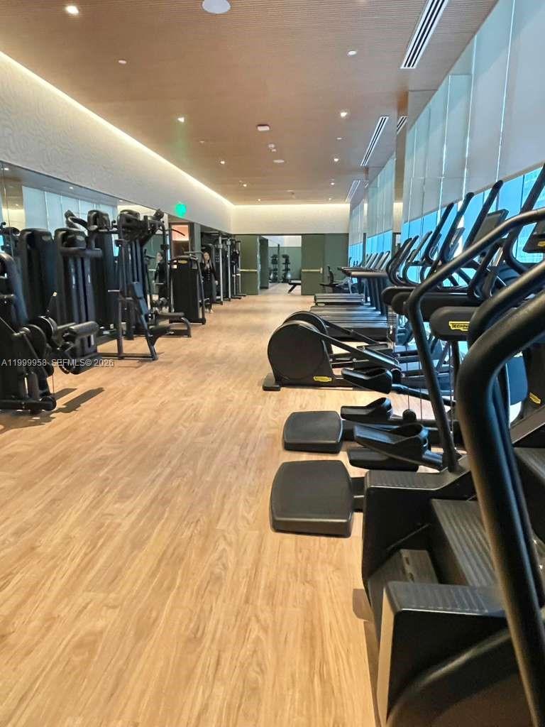77 Southeast 5th Street, Unit 2905 Miami, FL 33131 - Photo 11 of 27 a room with lots of chairs and mirrors