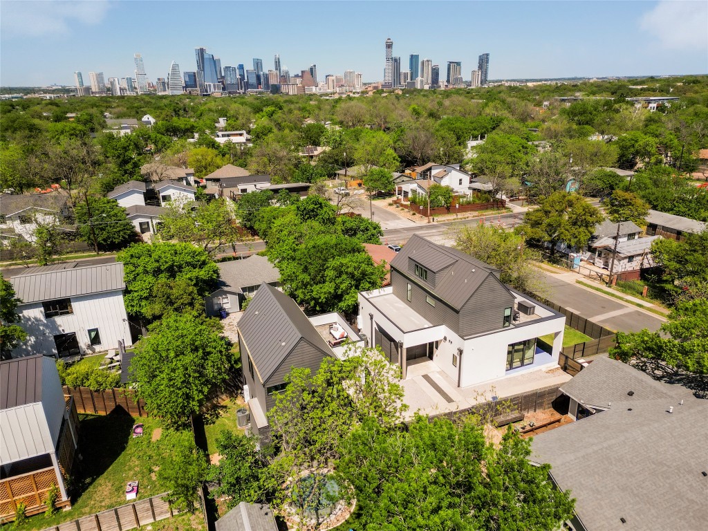 an aerial view of multiple houses with yard
