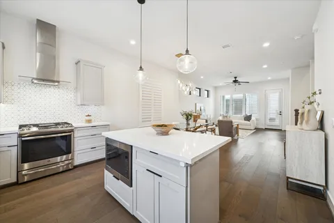 a view of a kitchen counter top space a sink stainless steel appliances and cabinets
