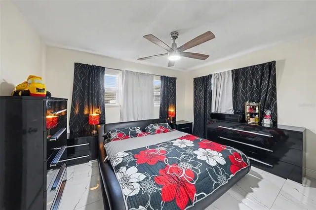 a bedroom with a bed and a flat tv screen