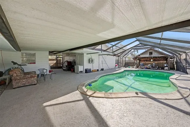 a view of a porch with furniture and a small yard