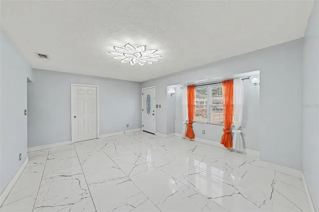 a view of an empty room with a window