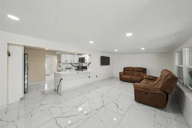a living room with furniture and white doors