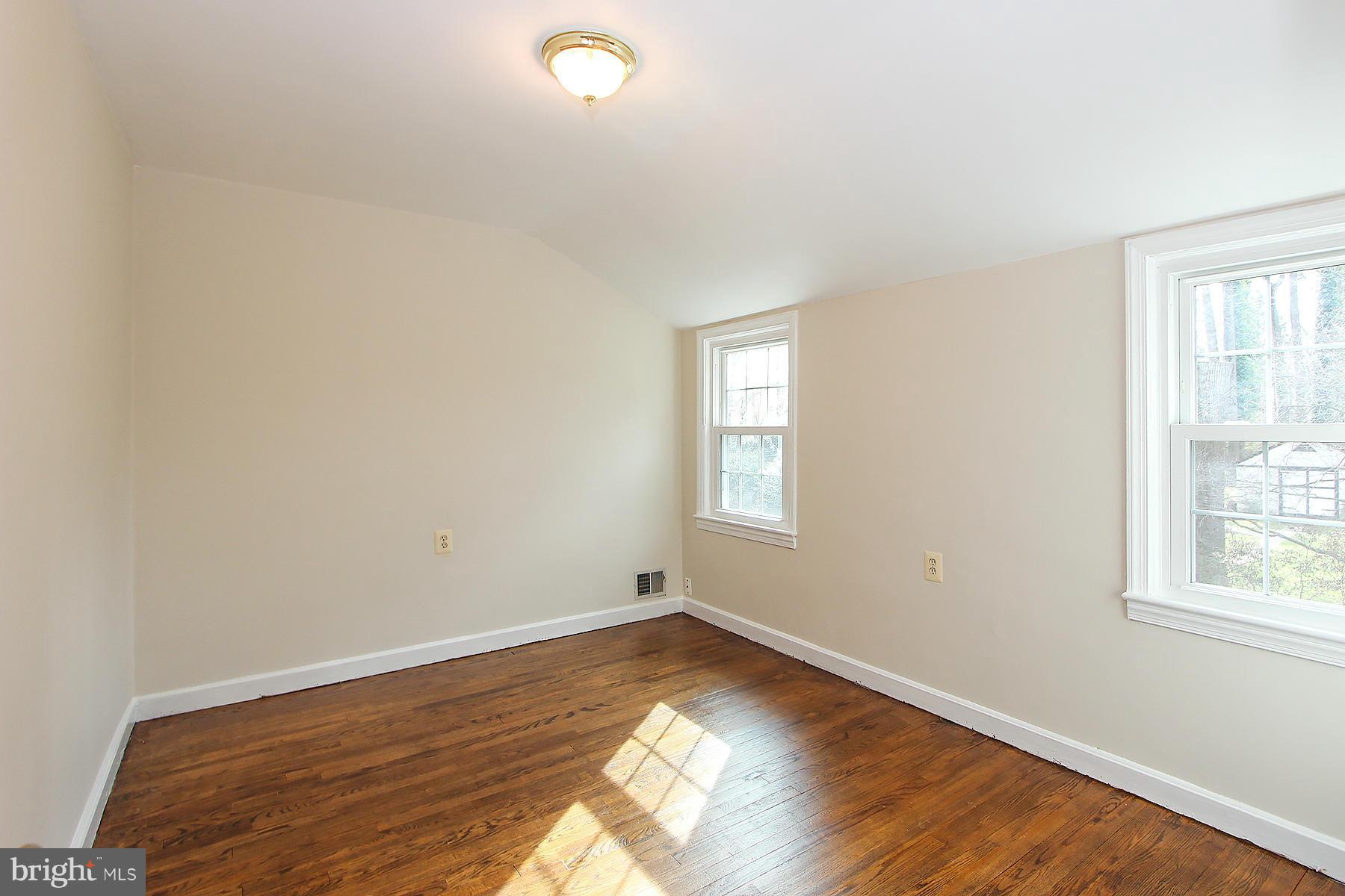 1111 Notley Road Silver Spring, MD 20904 - Photo 18 of 30 an empty room with wooden floor and windows