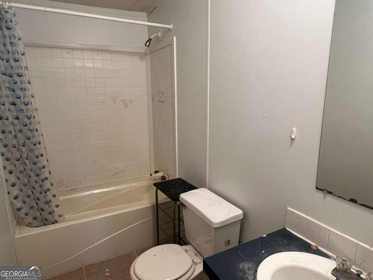 300 Josephine Park Road Waycross, GA 31503 - Photo 11 of 19 a white toilet and tub sitting next to a bathroom sink