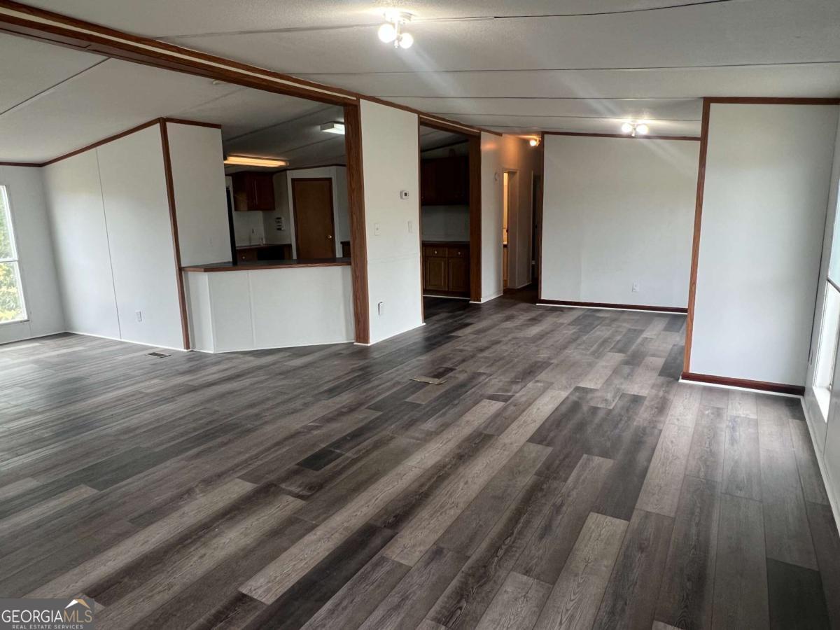 300 Josephine Park Road Waycross, GA 31503 - Photo 4 of 19 a view of a kitchen with wooden floor and a refrigerator