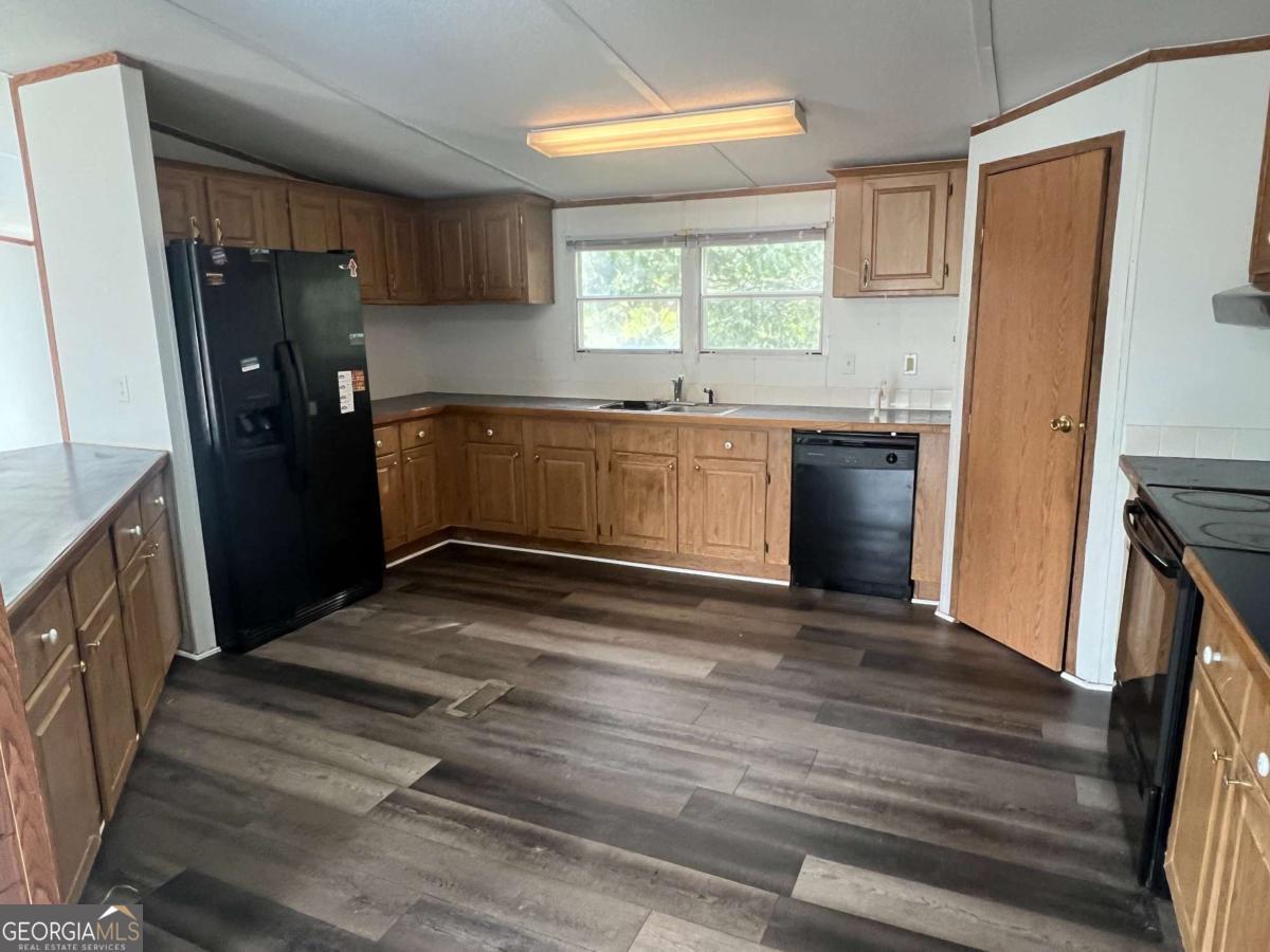 300 Josephine Park Road Waycross, GA 31503 - Photo 5 of 19 a kitchen with granite countertop a refrigerator and a sink