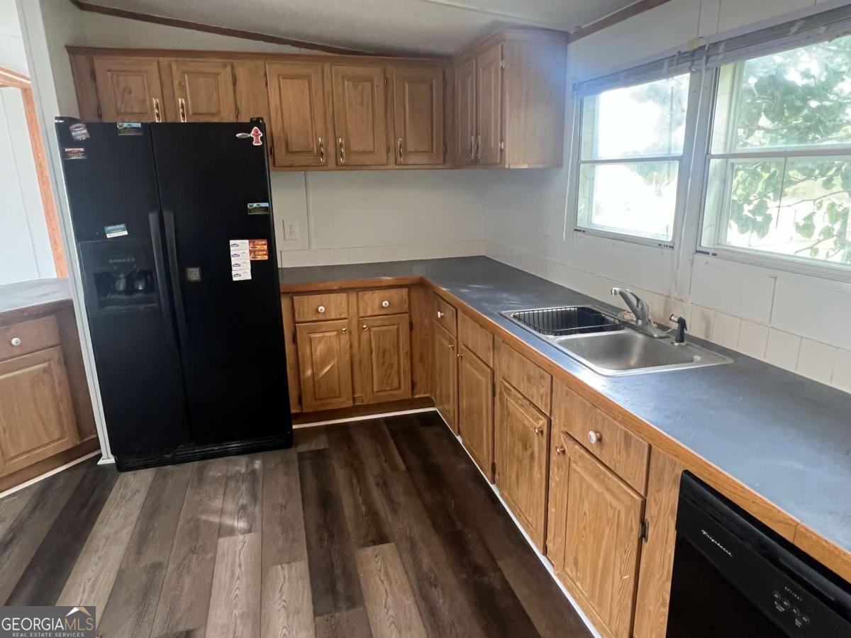300 Josephine Park Road Waycross, GA 31503 - Photo 6 of 19 a kitchen with stainless steel appliances granite countertop a refrigerator and a sink