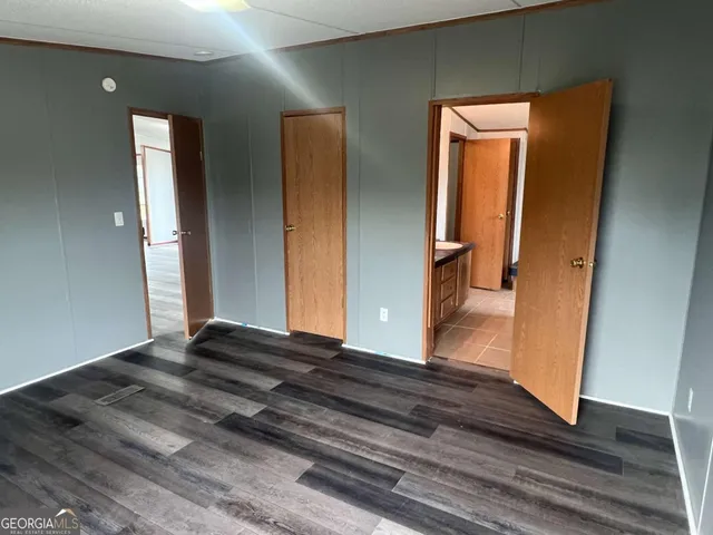 a view of a hallway view with wooden floor and front door