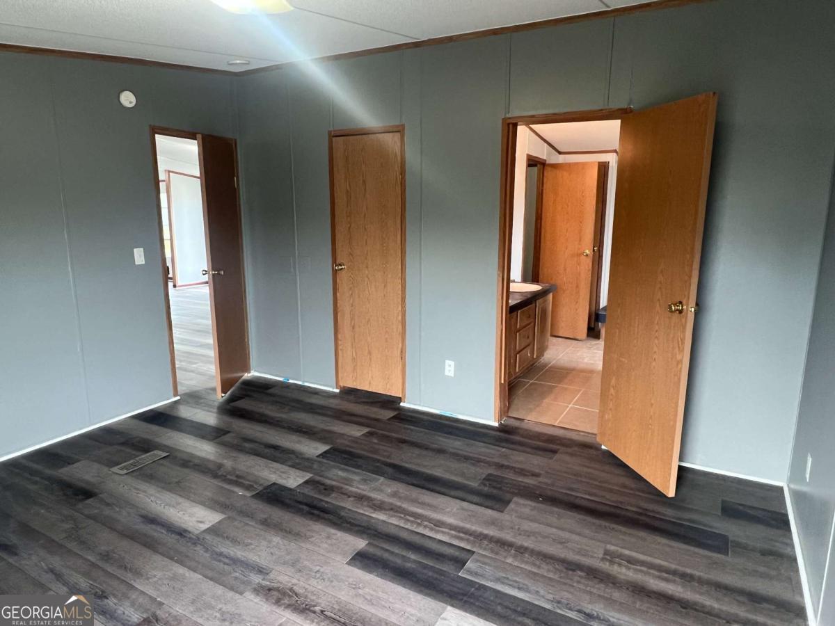 300 Josephine Park Road Waycross, GA 31503 - Photo 8 of 19 a view of a hallway view with wooden floor and front door