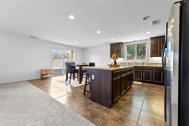 a kitchen with a sink counter top space appliances and a center island