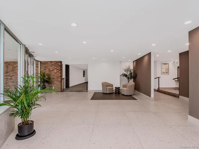 a view of a livingroom with furniture and a potted plant