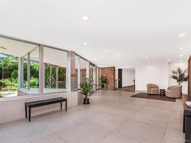 a building outdoor space with patio furniture and potted plants