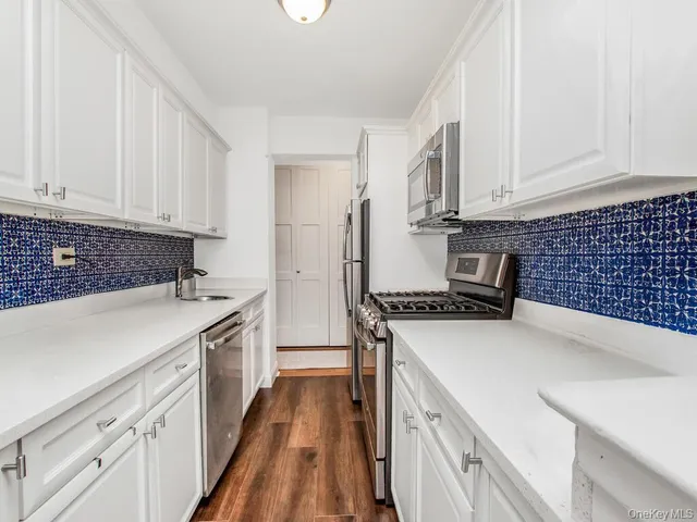 a kitchen with a stove a sink and a refrigerator