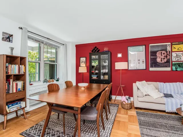 a living room with furniture and a book shelf