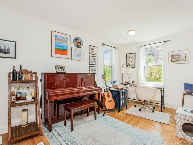 a living room with furniture a piano and a window