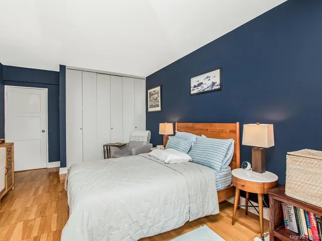 a bedroom with a bed and a lamp on table