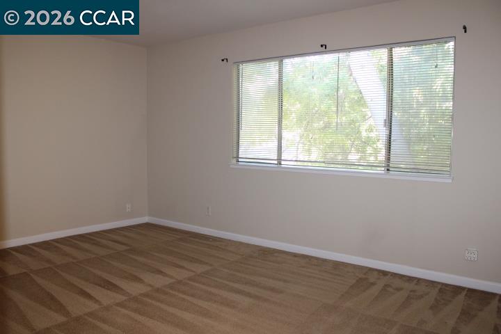 507 Chabre Court El Sobrante, CA 94803 - Photo 17 of 29 an empty room with wooden floor and windows