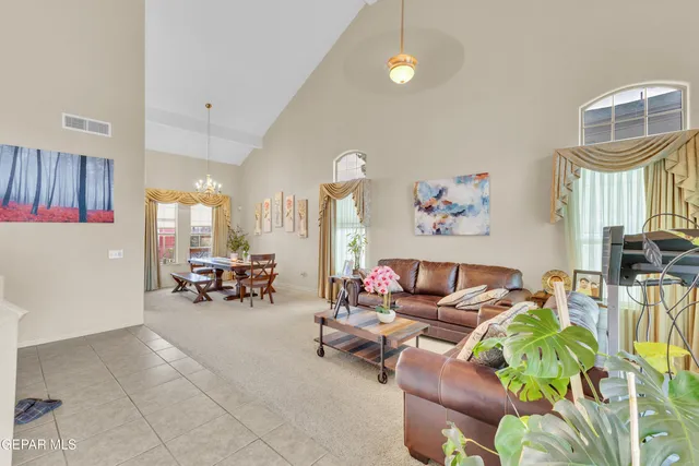 a living room with furniture and a chandelier