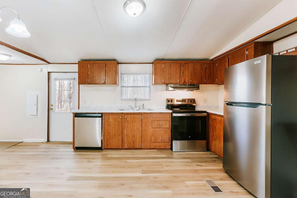 72 Frank Mathews Road Lexington, GA 30648 - Photo 11 of 36 a kitchen with granite countertop a refrigerator stove top oven and sink