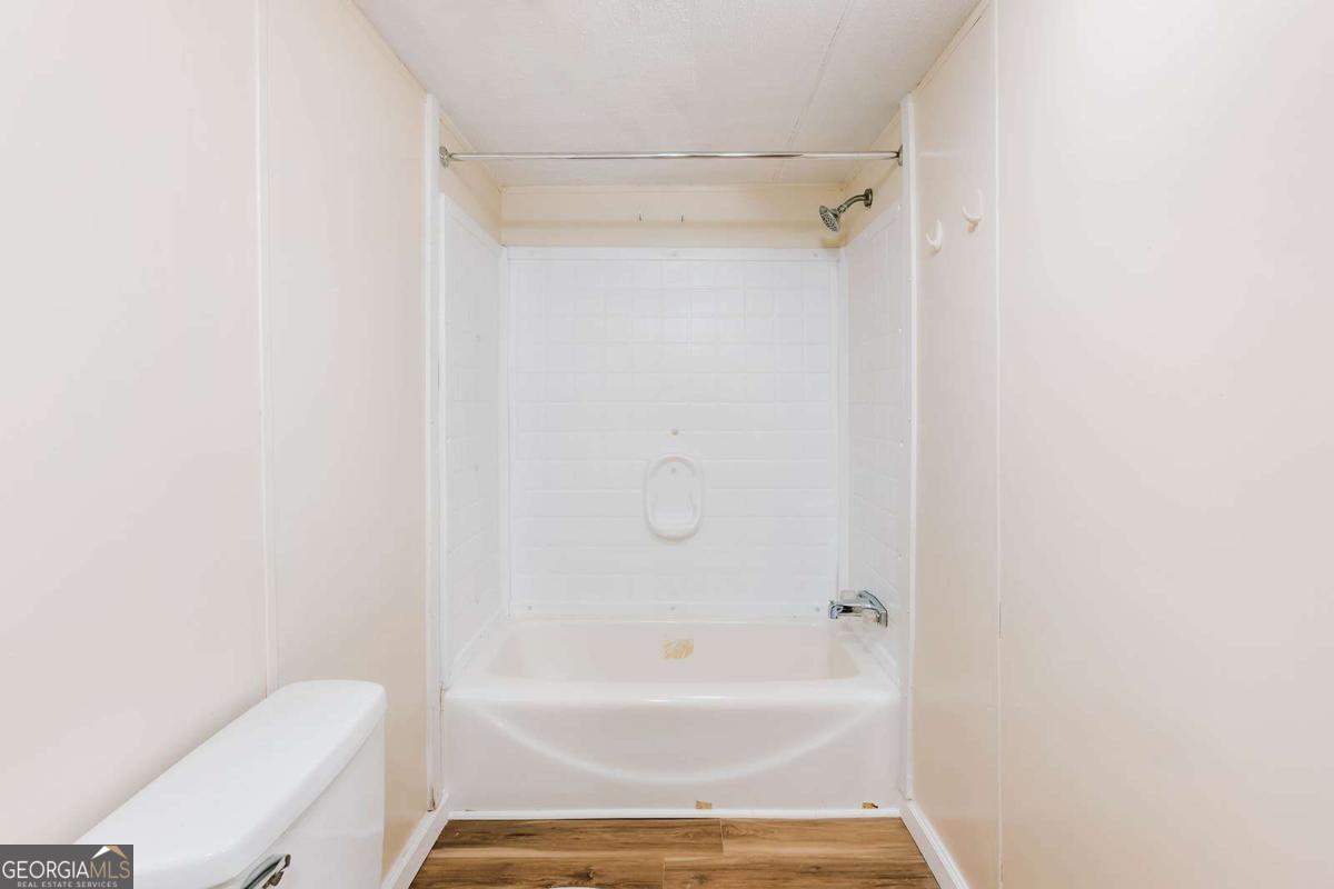 72 Frank Mathews Road Lexington, GA 30648 - Photo 16 of 36 a bathroom with a bathtub and a toilet