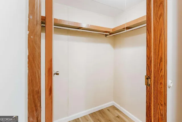 a view of walk in closet with clothes