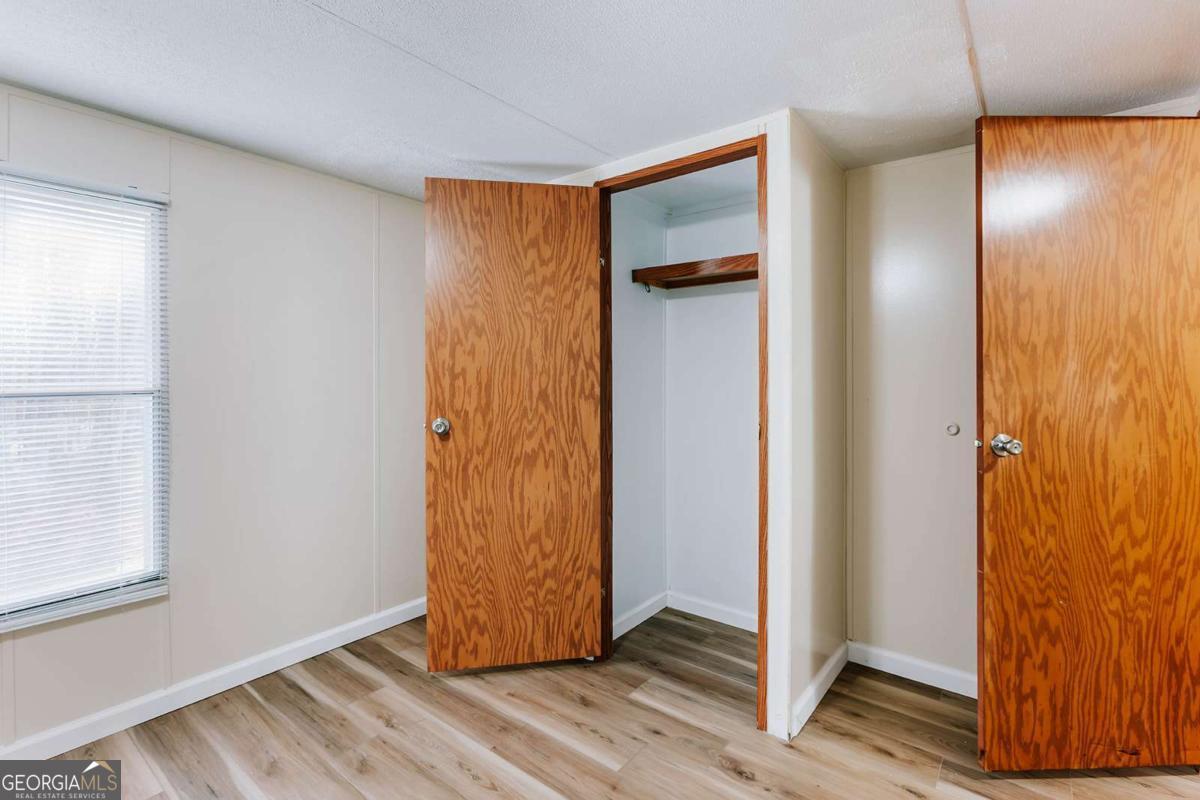 72 Frank Mathews Road Lexington, GA 30648 - Photo 21 of 36 a view of a hallway with wooden floor and closet area
