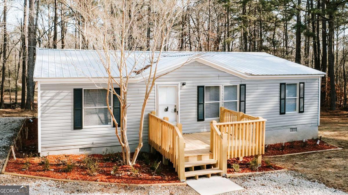 72 Frank Mathews Road Lexington, GA 30648 - Photo 3 of 36 a front view of a house with garden