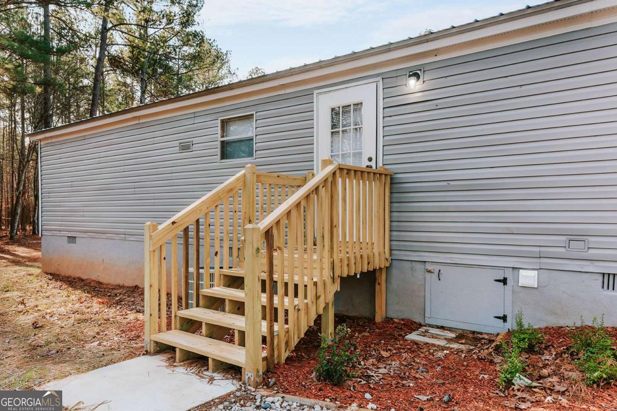 72 Frank Mathews Road Lexington, GA 30648 - Photo 5 of 36 a view of small house with wooden stairs