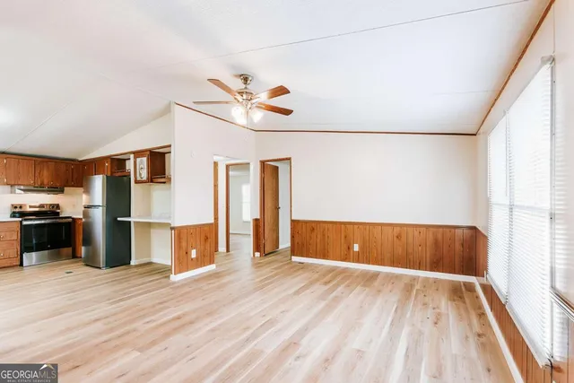 a view of a kitchen with wooden floor and a ceiling fan