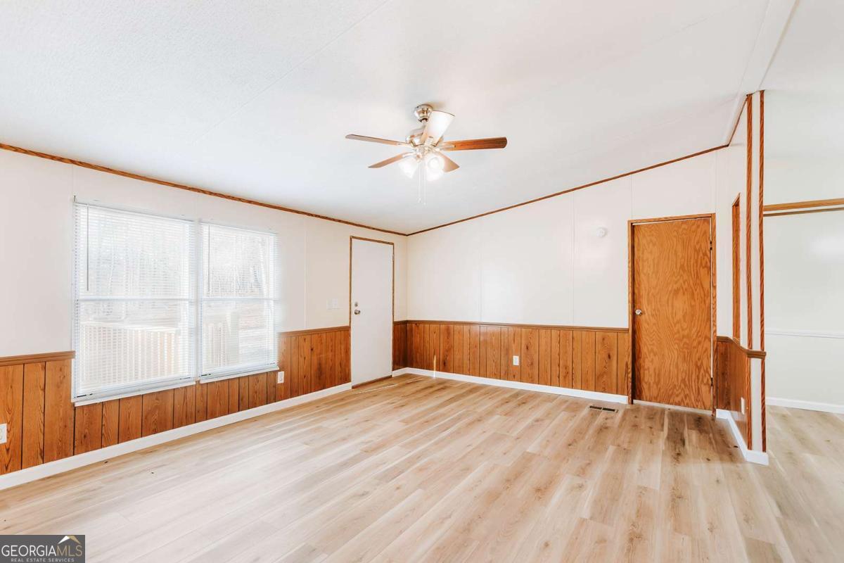 72 Frank Mathews Road Lexington, GA 30648 - Photo 10 of 36 wooden floor in an empty room with a window