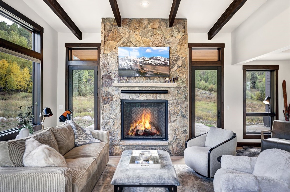 160 Vendette Road Silverthorne, CO 80498 - Photo 11 of 50 Living area featuring a fireplace and beamed ceiling