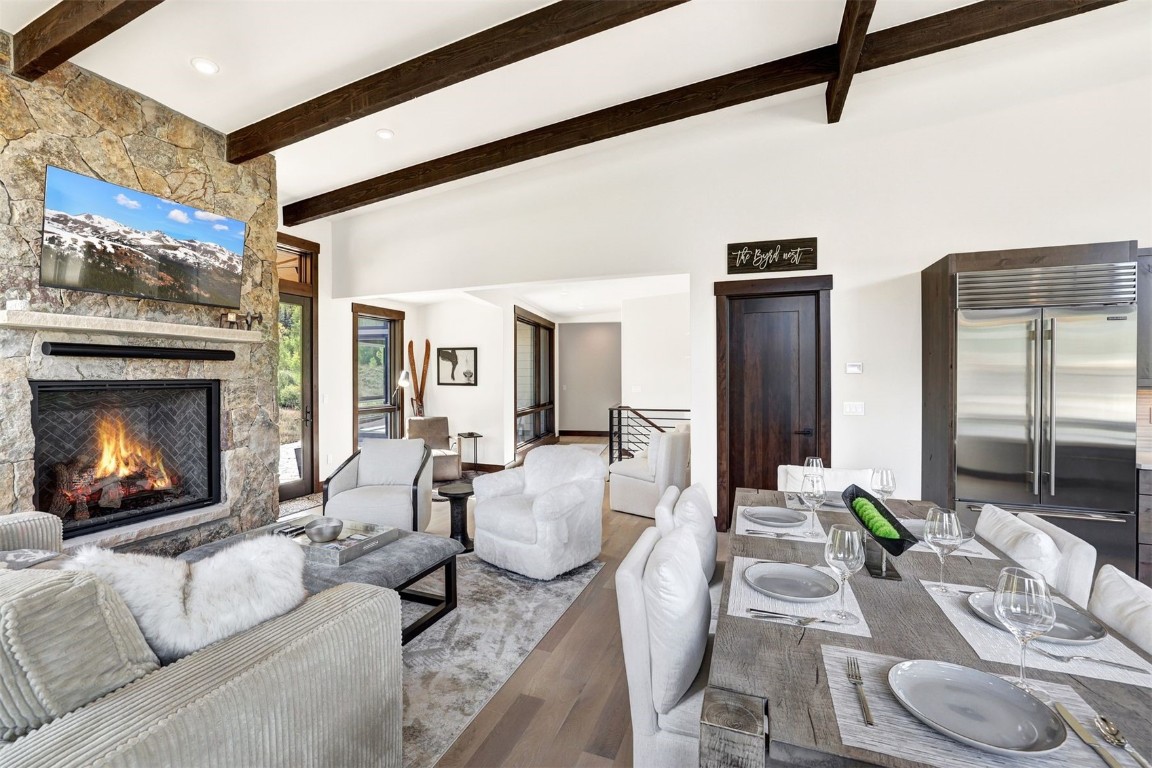 160 Vendette Road Silverthorne, CO 80498 - Photo 13 of 50 Living room featuring beam ceiling, wood finished floors, and a fireplace