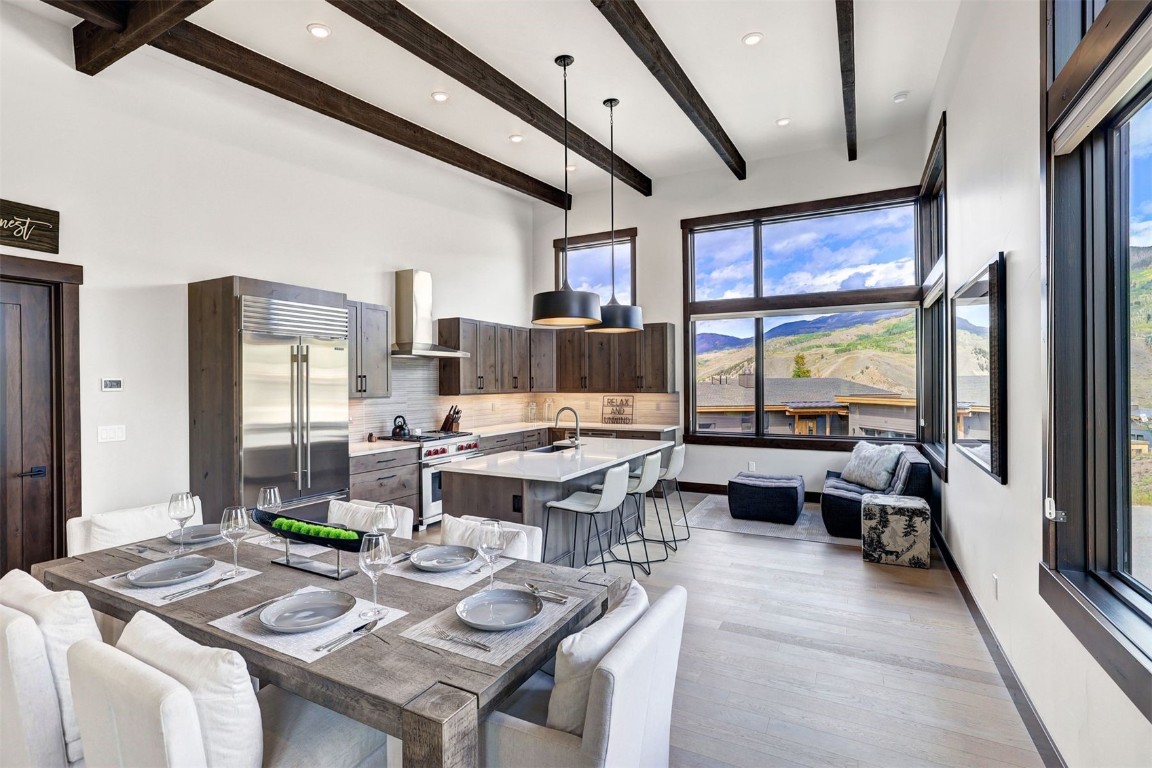 160 Vendette Road Silverthorne, CO 80498 - Photo 14 of 50 Dining room featuring light wood finished floors, a mountain view, beam ceiling, and recessed lighting