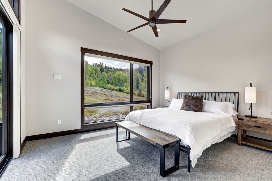 160 Vendette Road Silverthorne, CO 80498 - Photo 23 of 50 Bedroom with light colored carpet, a ceiling fan, and high vaulted ceiling