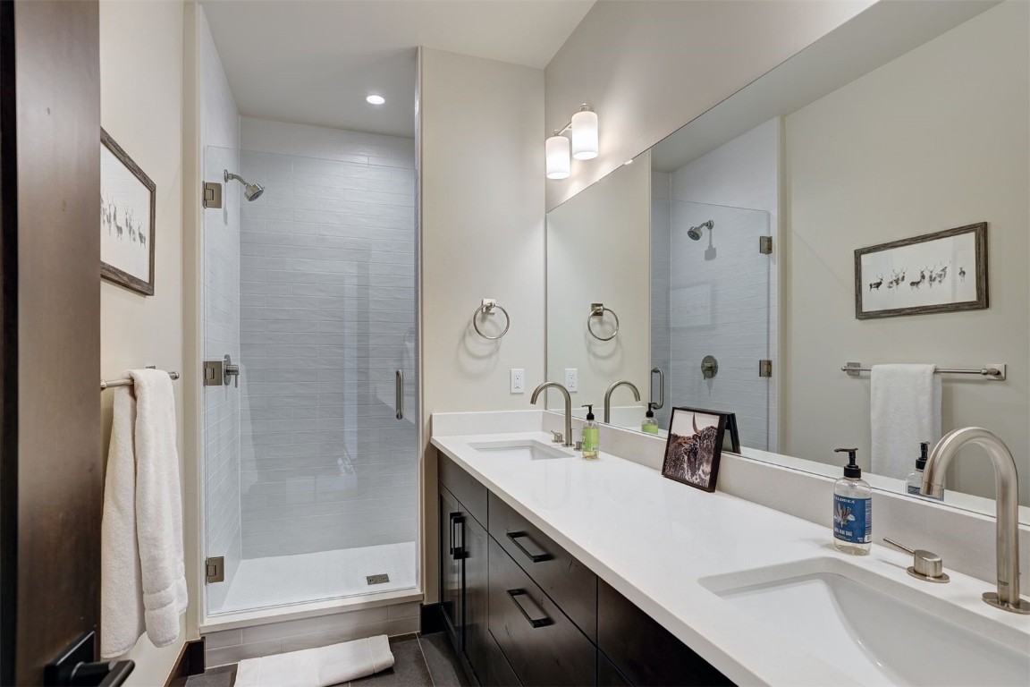 160 Vendette Road Silverthorne, CO 80498 - Photo 24 of 50 Full bath with double vanity, a shower stall, and recessed lighting
