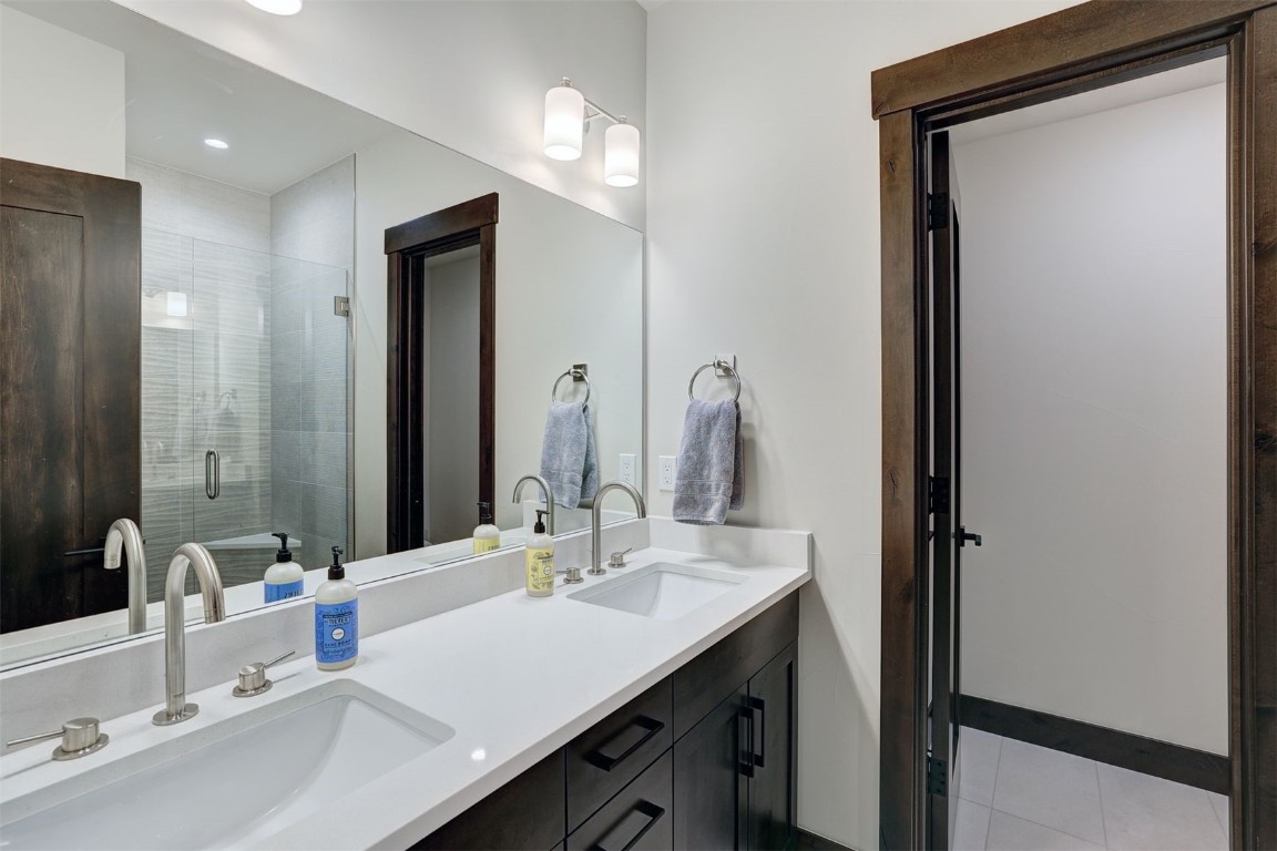 160 Vendette Road Silverthorne, CO 80498 - Photo 33 of 50 Bathroom featuring double vanity, a stall shower, and light tile patterned floors