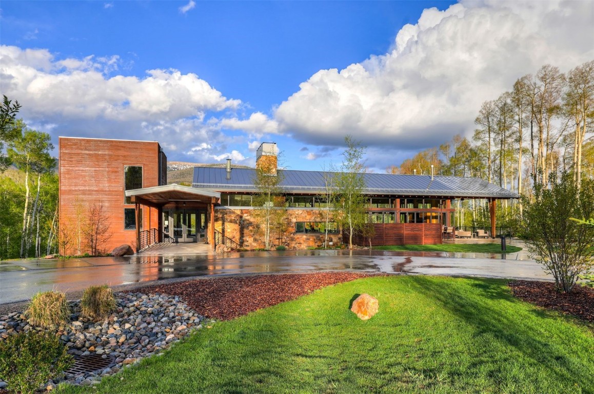 160 Vendette Road Silverthorne, CO 80498 - Photo 40 of 50 Back of house featuring a patio area, a metal roof, a chimney, and a lawn