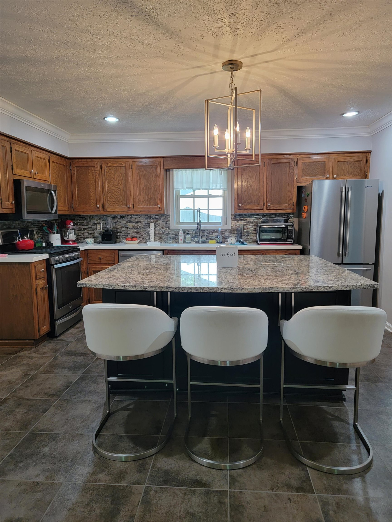48 Windy Hill Road Jackson, TN 38305 - Photo 3 of 20 a kitchen with a dining table chairs stove and kitchen view