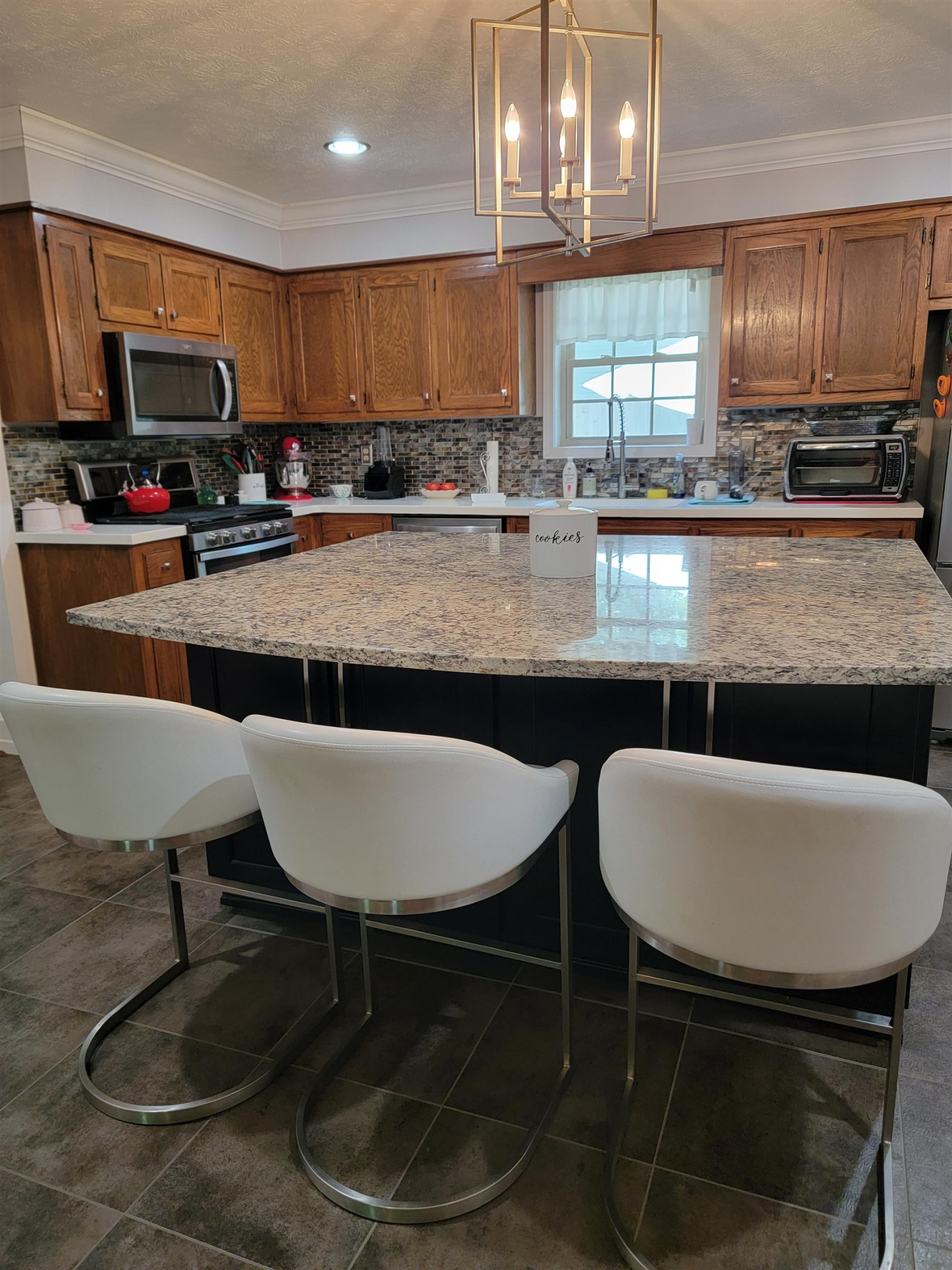 48 Windy Hill Road Jackson, TN 38305 - Photo 4 of 20 a kitchen with stainless steel appliances granite countertop a dining table chairs microwave and sink