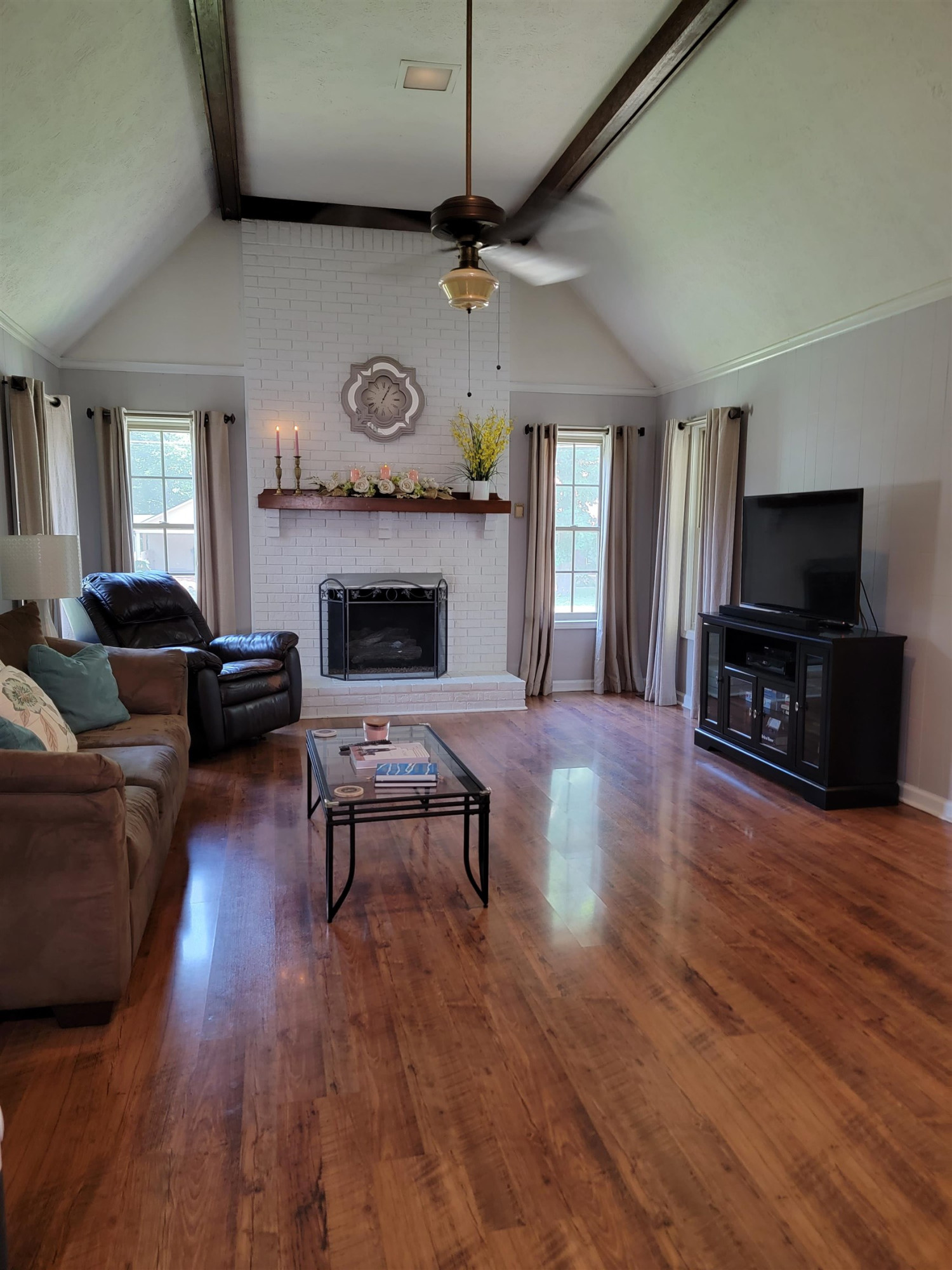 48 Windy Hill Road Jackson, TN 38305 - Photo 10 of 20 a living room with furniture a fireplace a flat screen tv and kitchen view