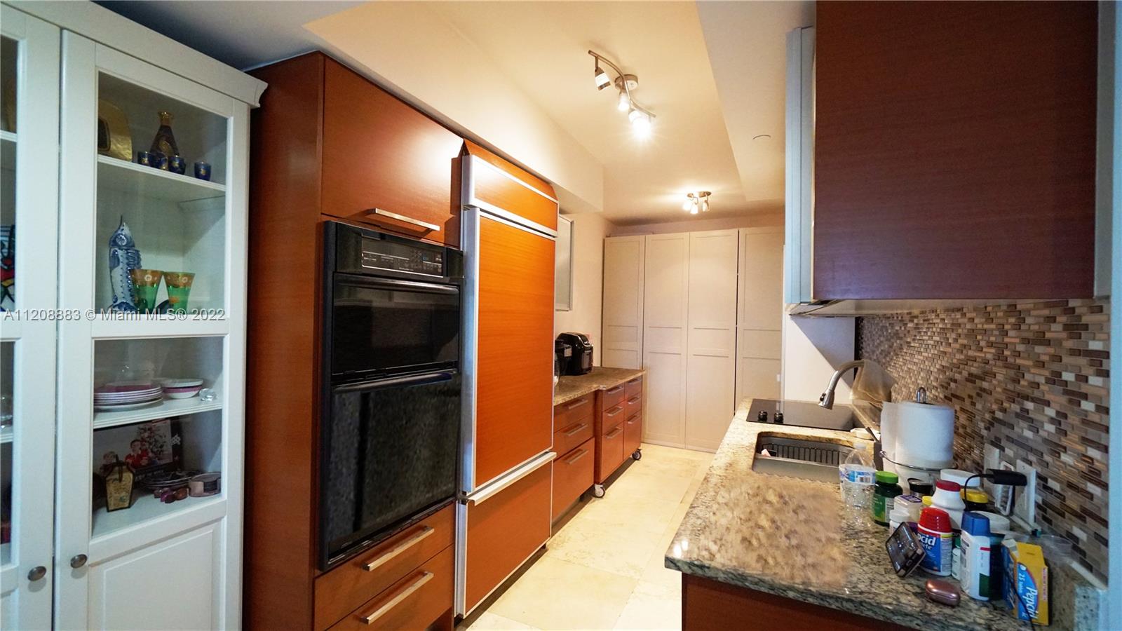 a kitchen with refrigerator and cabinets