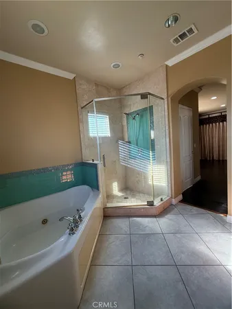 an empty room with wooden floor a glass door and a yard