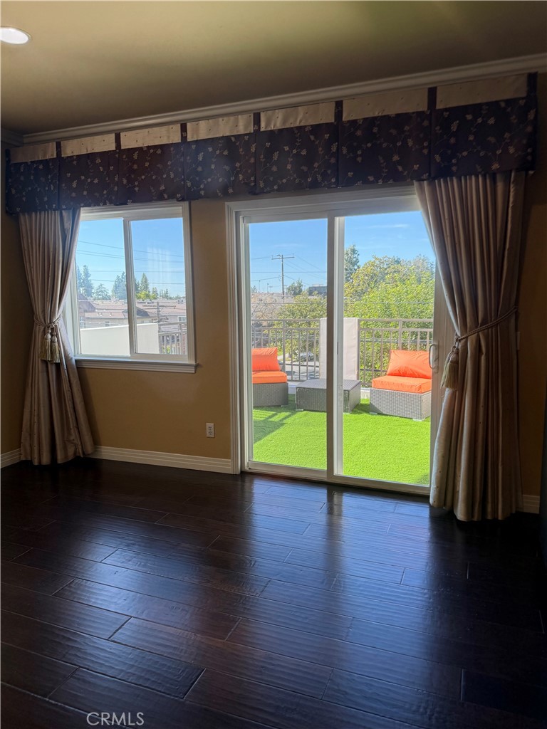 57 Alice Street, Unit A Arcadia, CA 91006 - Photo 20 of 34 an empty room with wooden floor a glass door and a yard