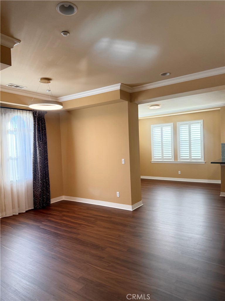 57 Alice Street, Unit A Arcadia, CA 91006 - Photo 4 of 34 an empty room with wooden floor and windows with curtains