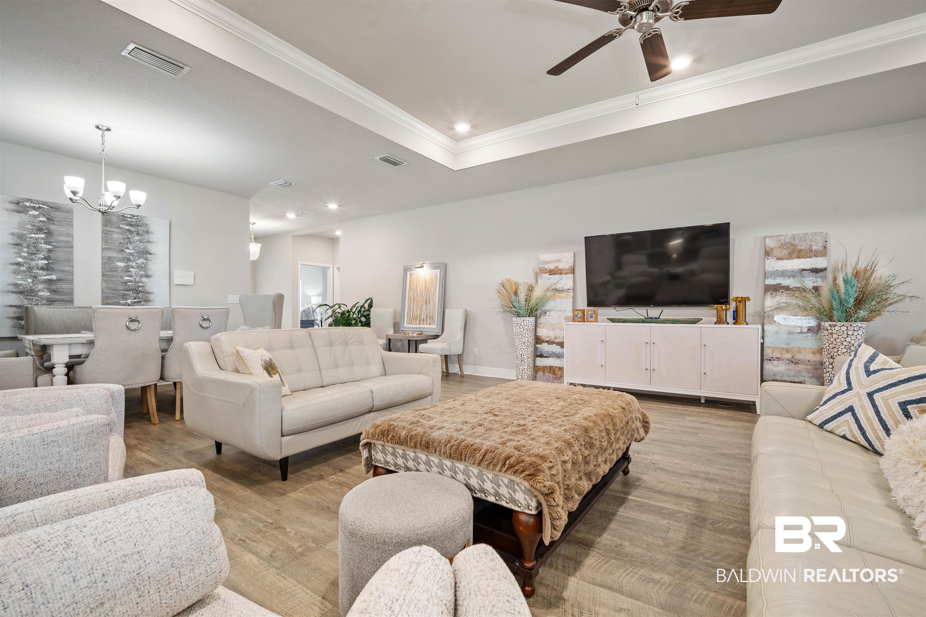 10474 Loamy Avenue Mobile, AL 36695 - Photo 5 of 31 Living room featuring ornamental molding, recessed lighting, light wood-style floors, a tray ceiling, and a chandelier