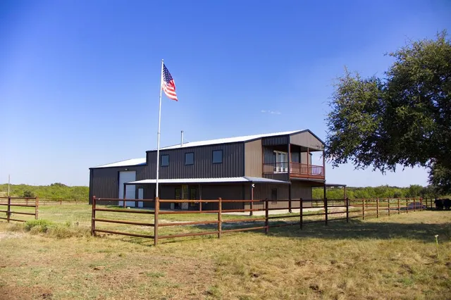 a view of a house with a yard and sitting area