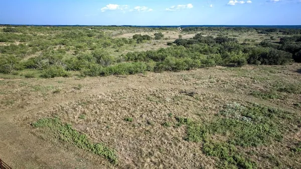 a view of a lake with houses in background