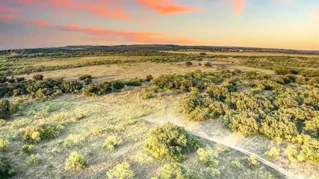 a view of a lake with a yard