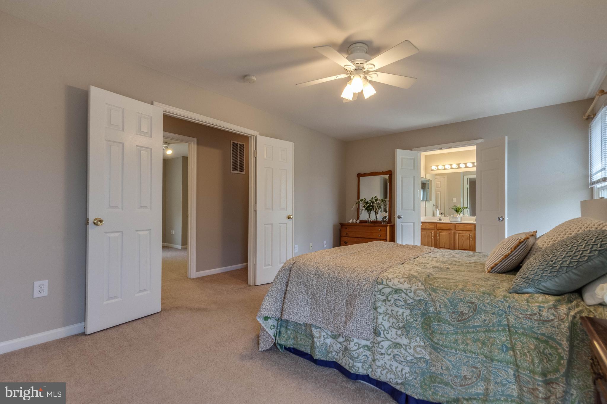 1746 Canal Run Drive Point of Rocks, MD 21777 - Photo 18 of 30 a bedroom with a large bed and a chandelier